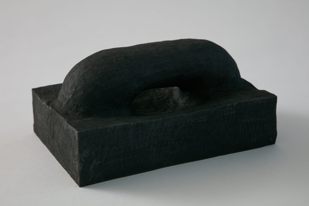 A black sculpture of an arch, hint at the playful disposition of the form