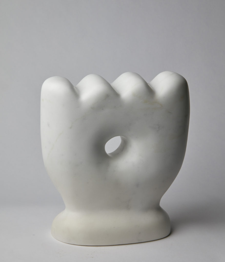 A white sculpture of an arch, hint at the playful disposition of the form