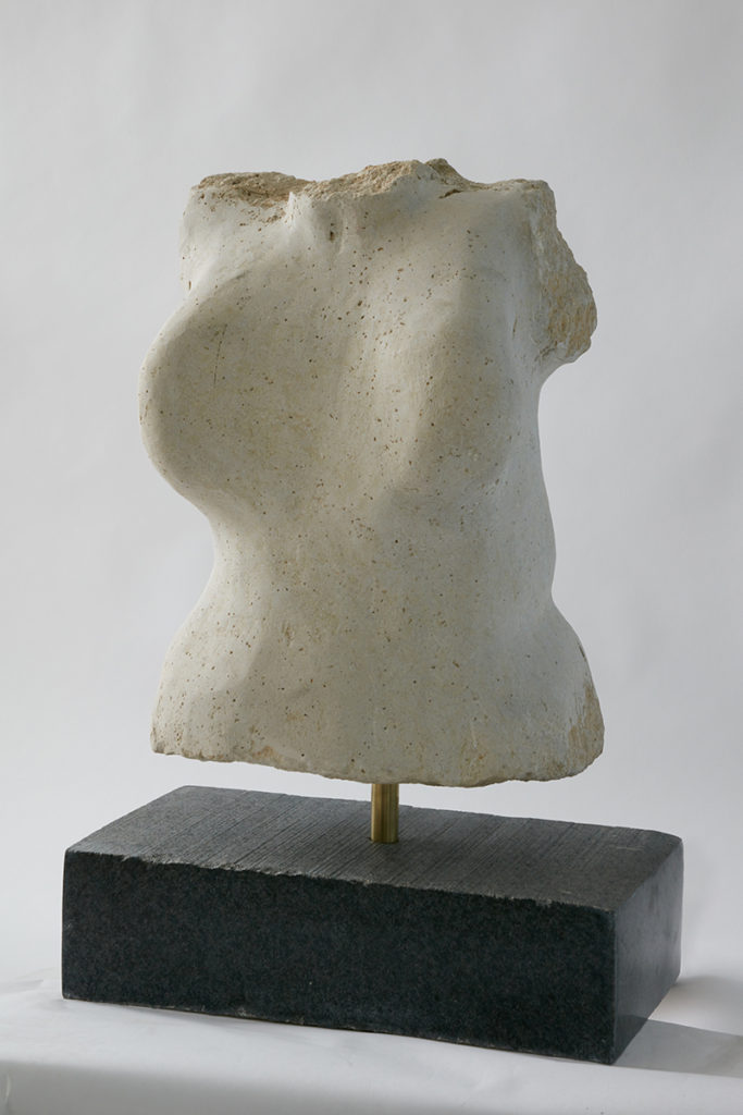 A white sculpture of female torso