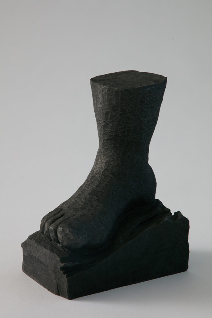 A black sculpture of right foot