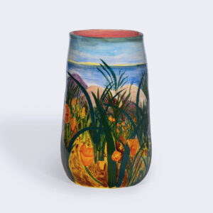 A landscape with wildflowers overlooking the lake is painted on a ceramic