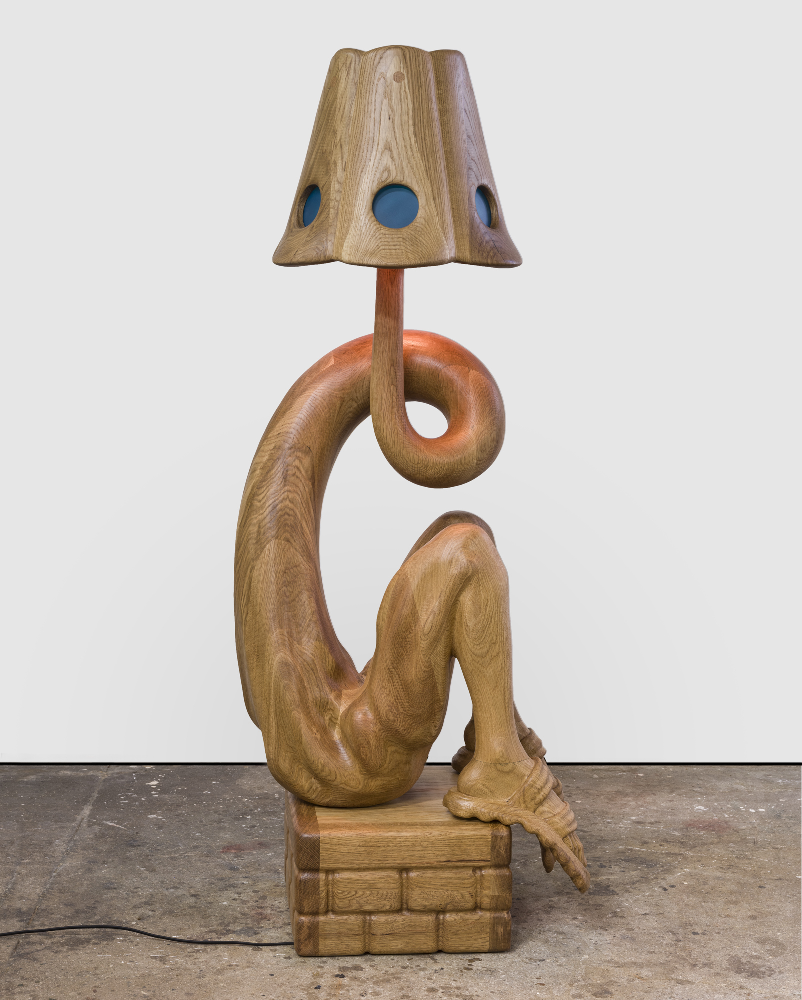 A wooden anthropomorphic lamp
